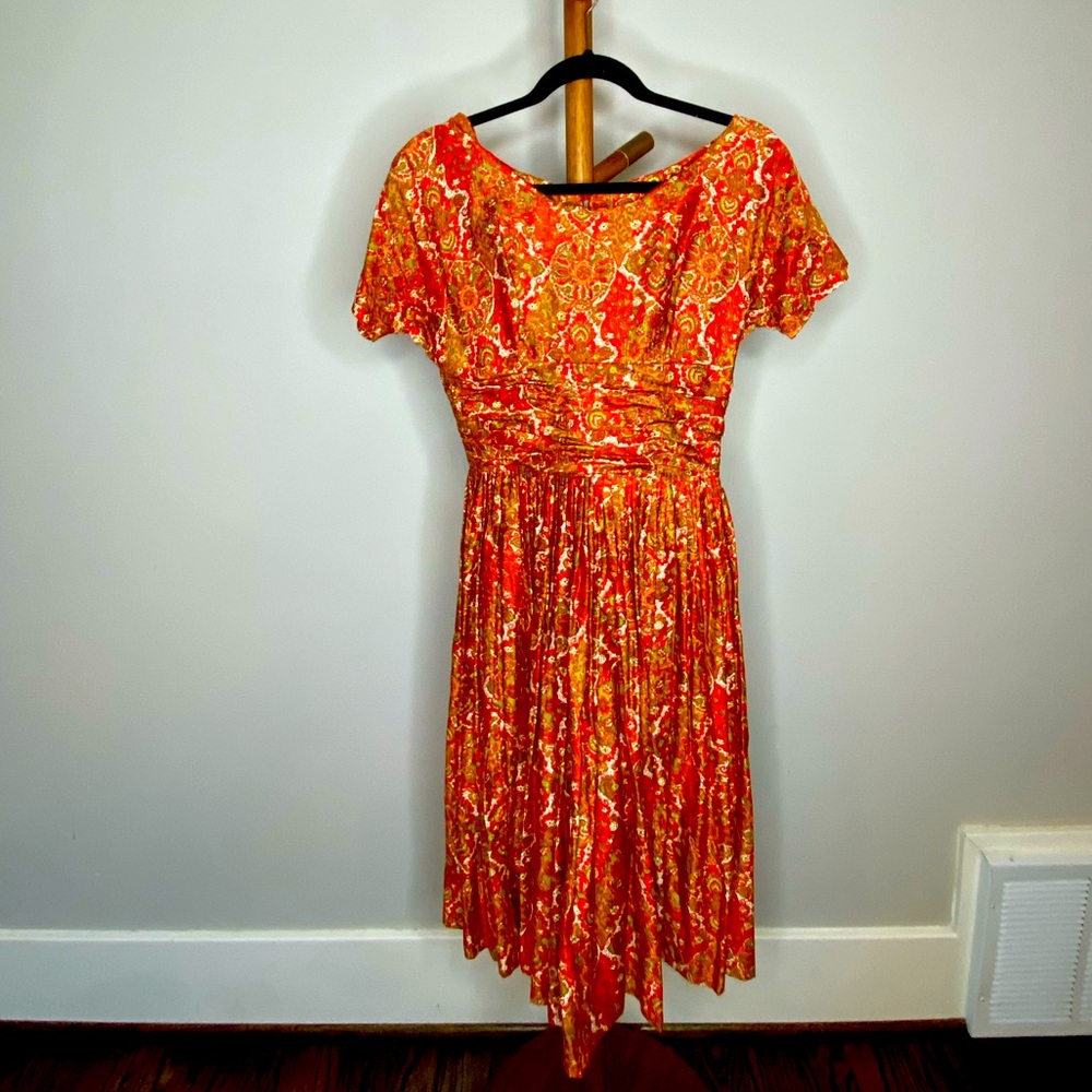 Vintage party dress with orange pattern.